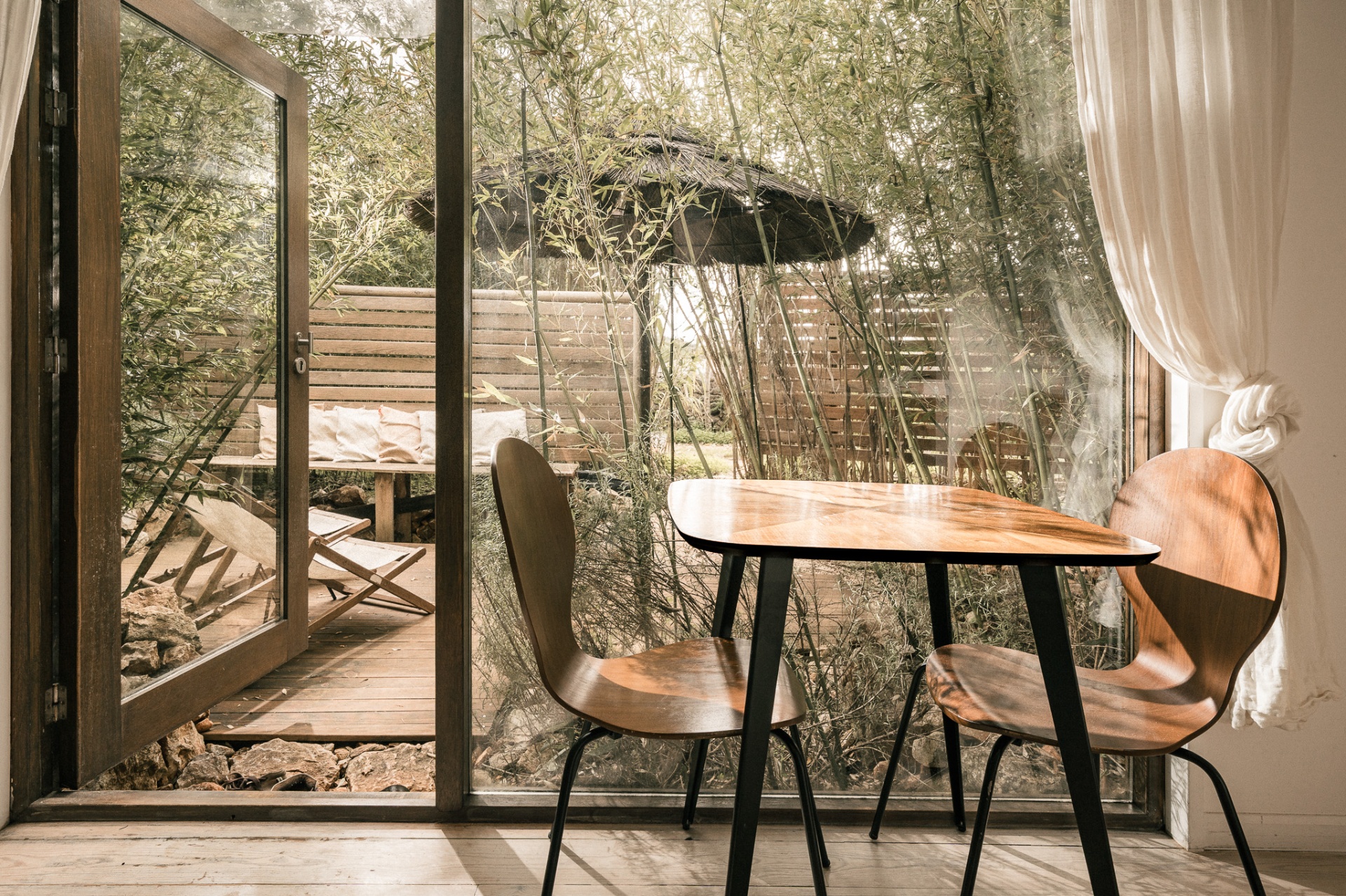 Tiny House Algarve — minimalist black timber cabin nestled among cork oaks in the Portuguese countryside