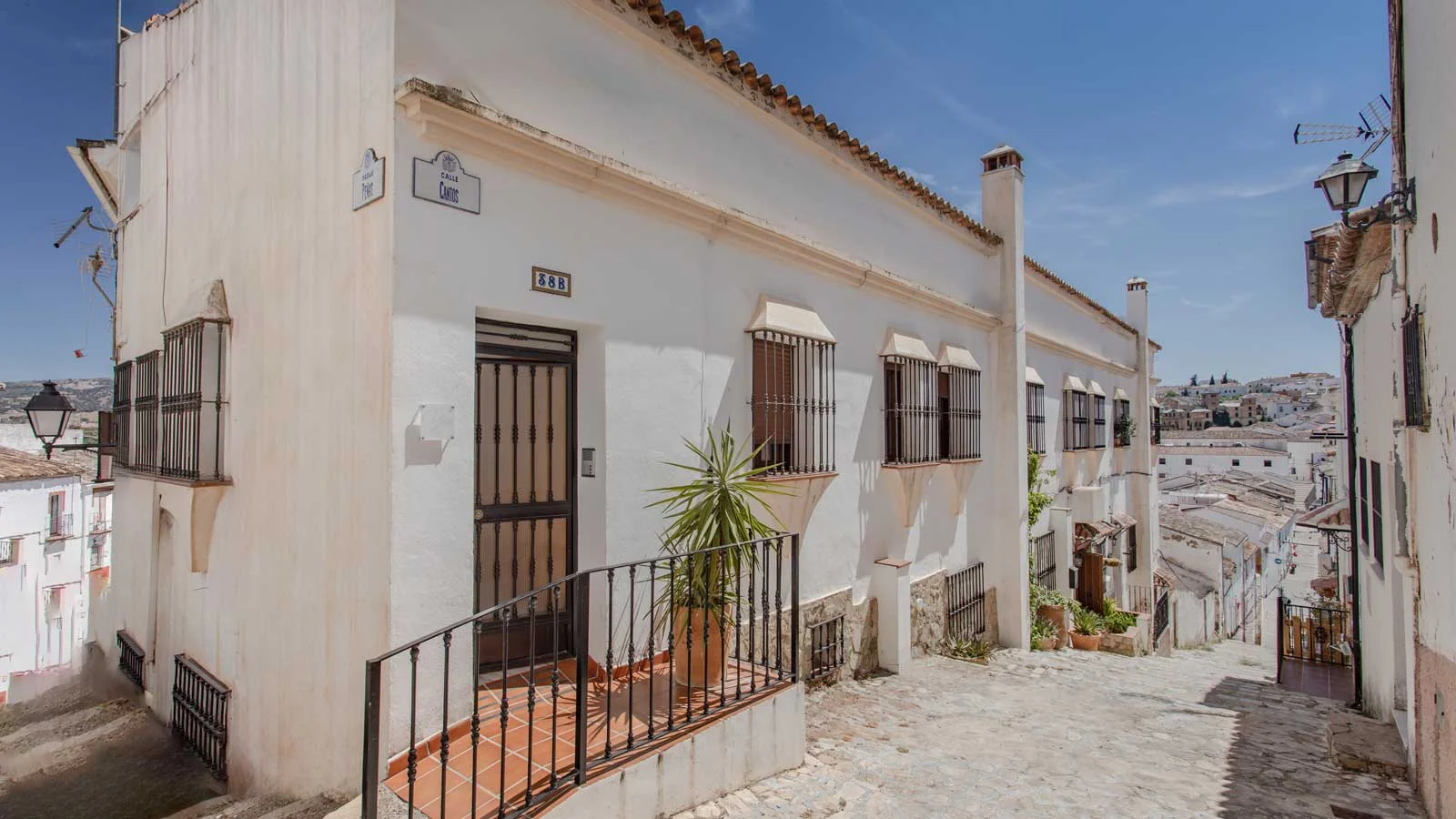 Yanes BnB Ronda — whitewashed Andalusian boutique B&B with red geraniums on wrought iron balconies